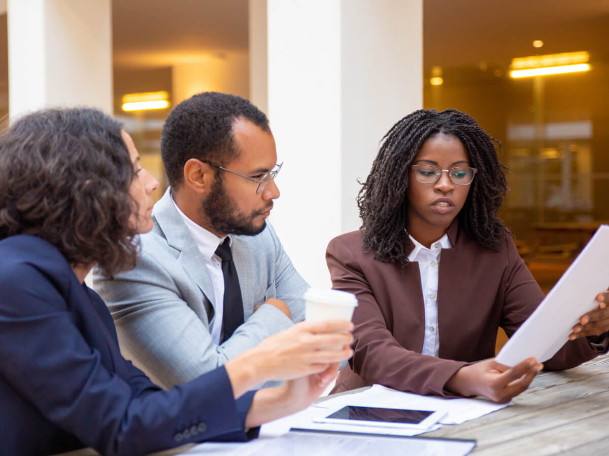 couple-with-female-lawyer-reviewing-document