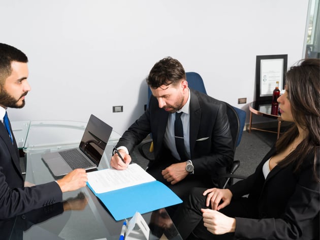 male-client-filling-document-with-spouse