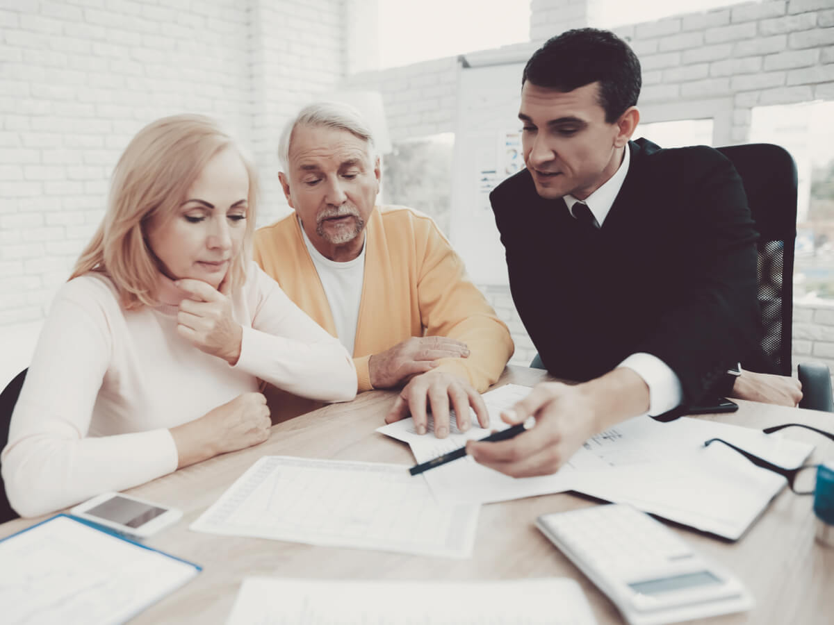 older-couple-reviewing-documents-with-lawyer