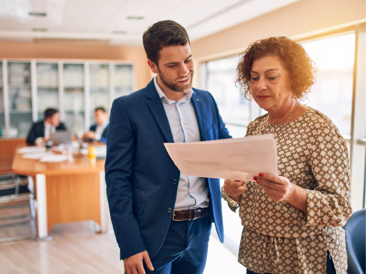 older-female-with-lawyer-reviewing-documents