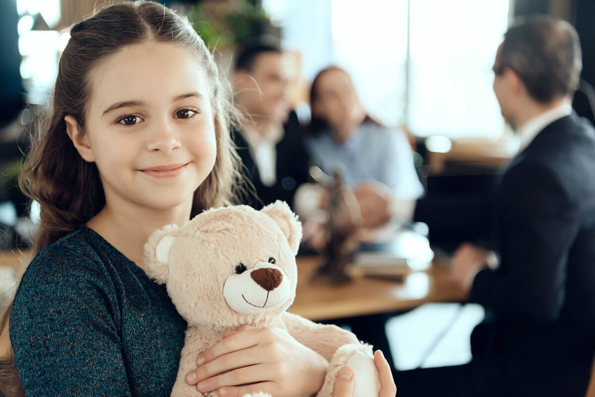 girl-smiling-holding-bear